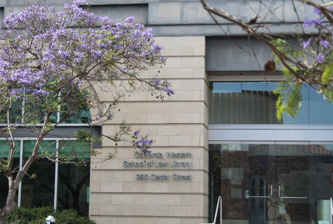A purple tree in front of California Western Law Library