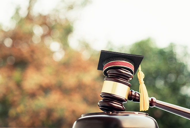 Graduation cap on top of gavel