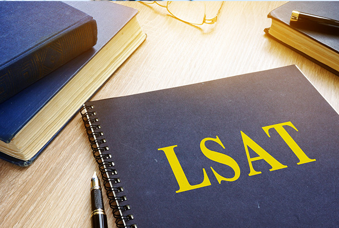 LSAT notebook on a desk with books