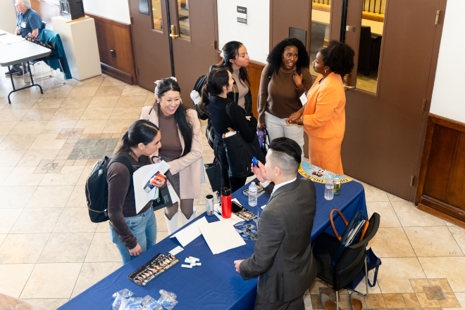 Career Fair attendees network around a table