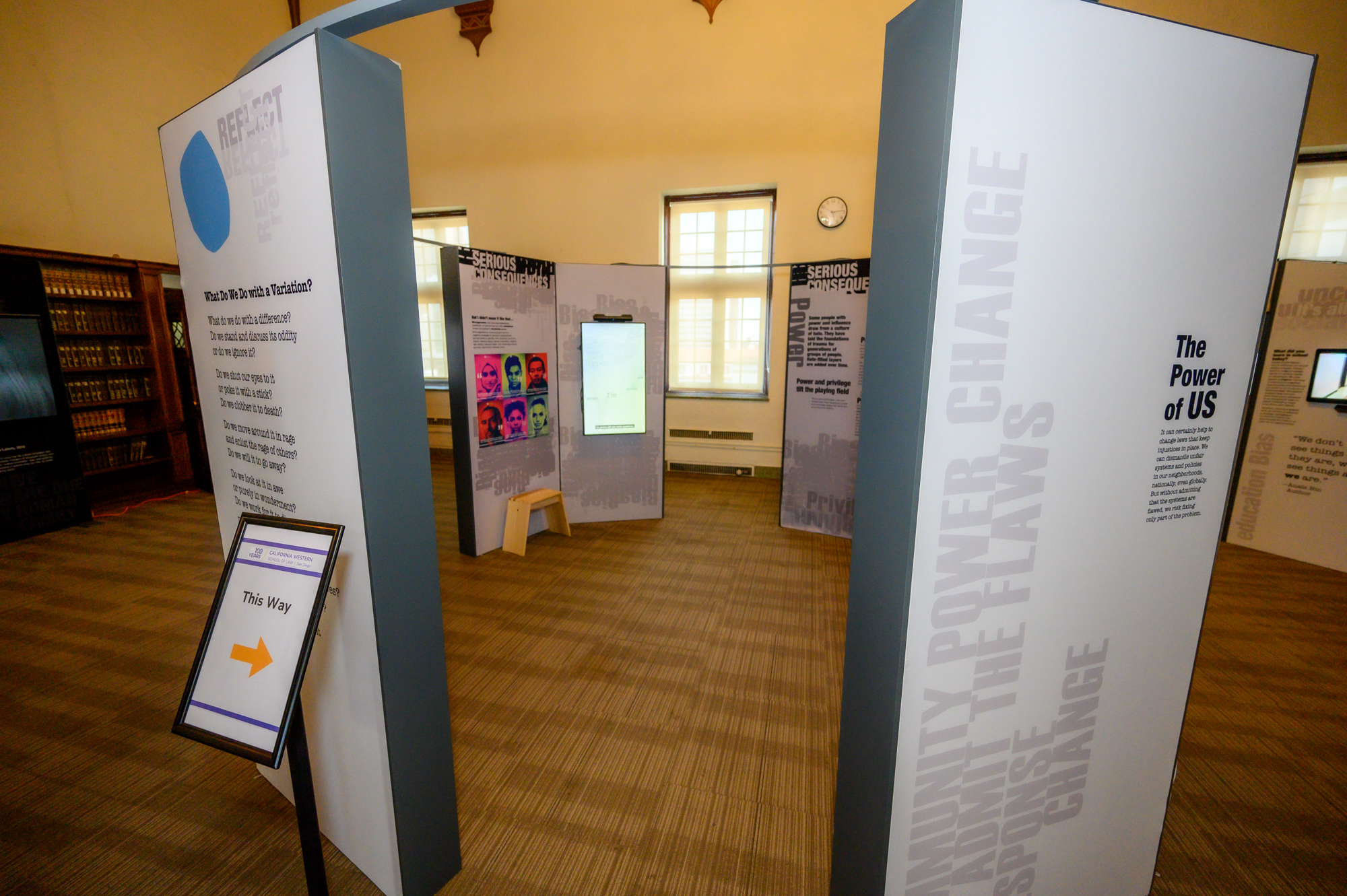 Large standing exhibit installations for "The Bias Inside Us" fill a large room.