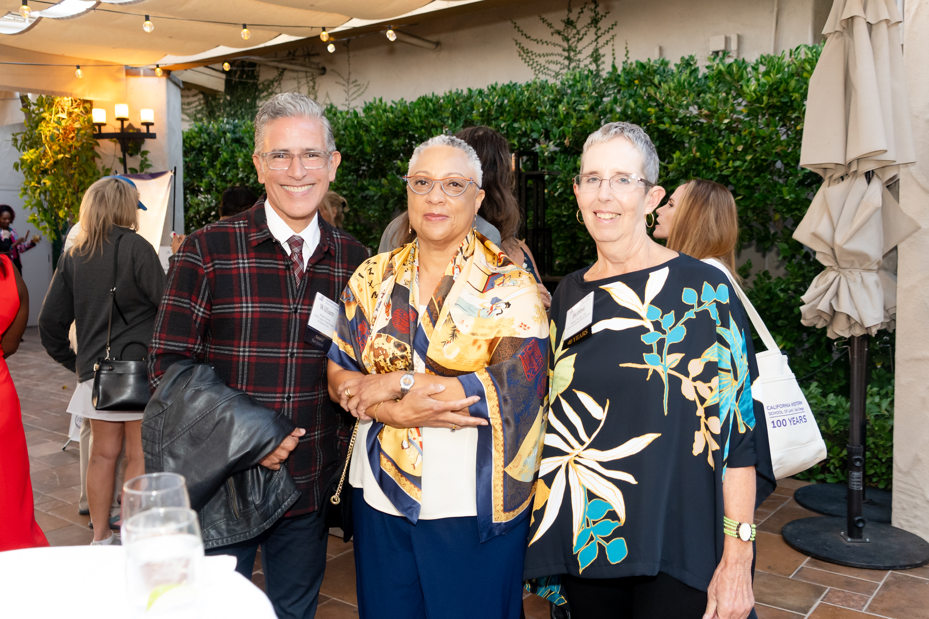 Professor William Aceves, Dean Sean Scott, and Emerita Professor "Bobbie" Thyfault pose for a photo.