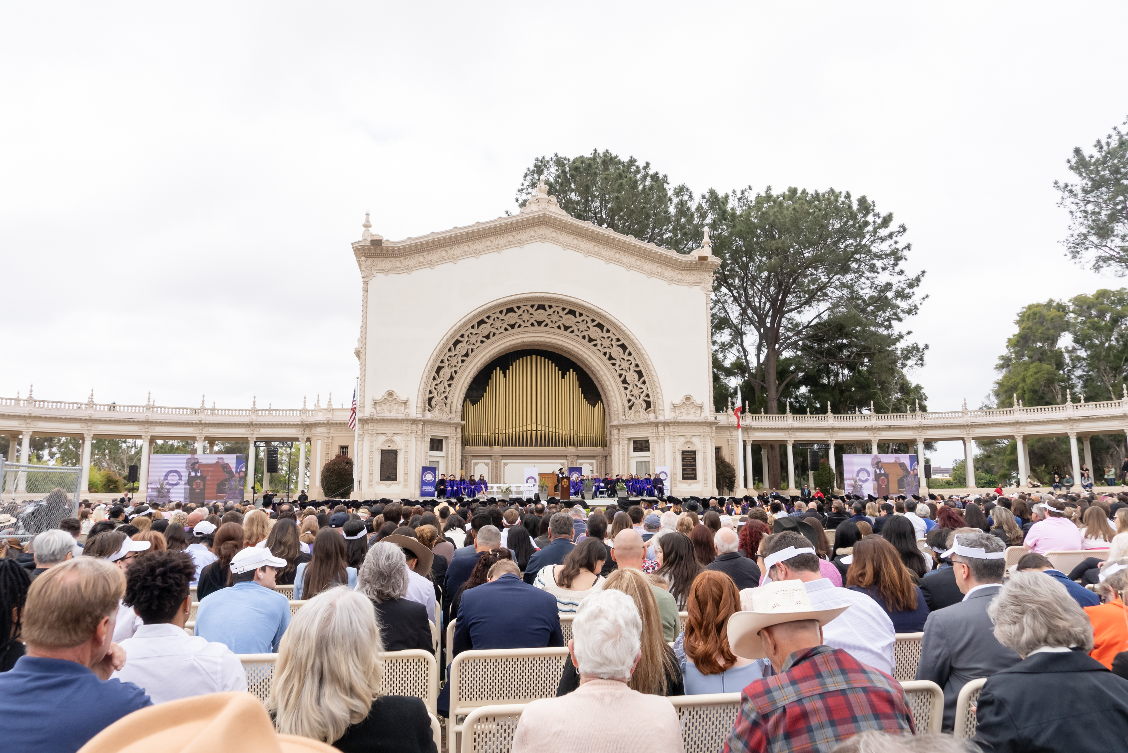 A very large crowd of people fills the outdoor Spreckels Organ Pavilion for the CWSL 2024 Commencement.