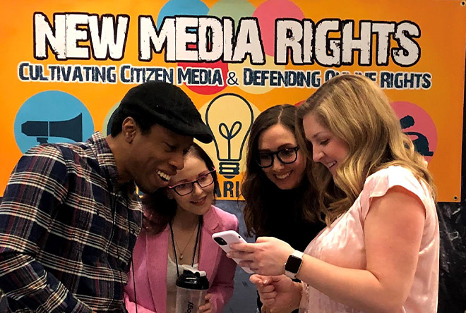 picture of new media rights interns and staff looking at photo