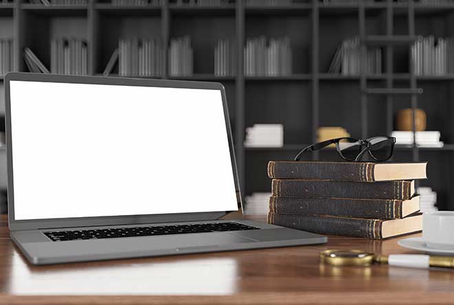 empty laptop with books on a table