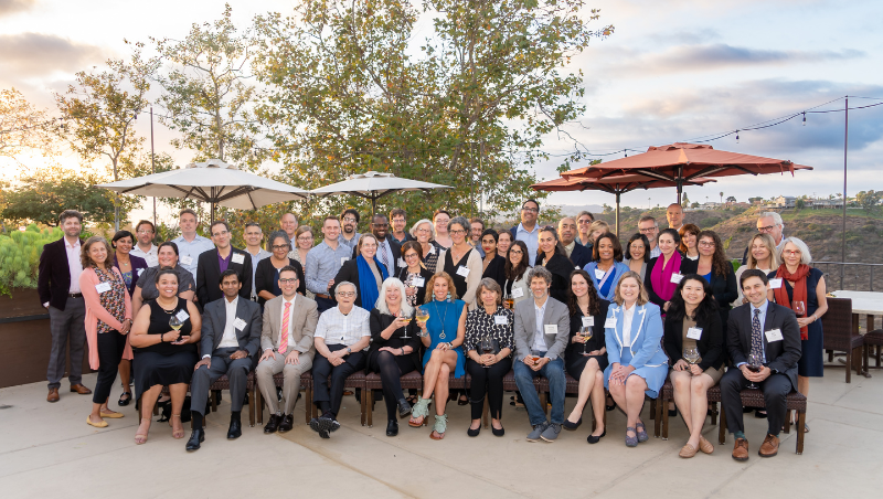 COSELL attendees pose for a group photo at the reception prior to the gala and awards ceremony. CWSL's Professor Susan Bisom-Rapp and USD's Professor Orly Lobel sit in the center of the front row in all black and all blue respectively.