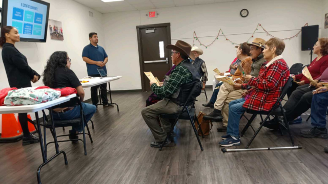 CLP student clinicians present to a crowd of senior citizens.