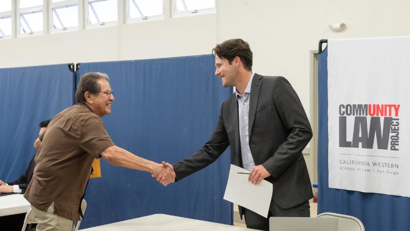 CLP student intern greets community member at free legal clinic