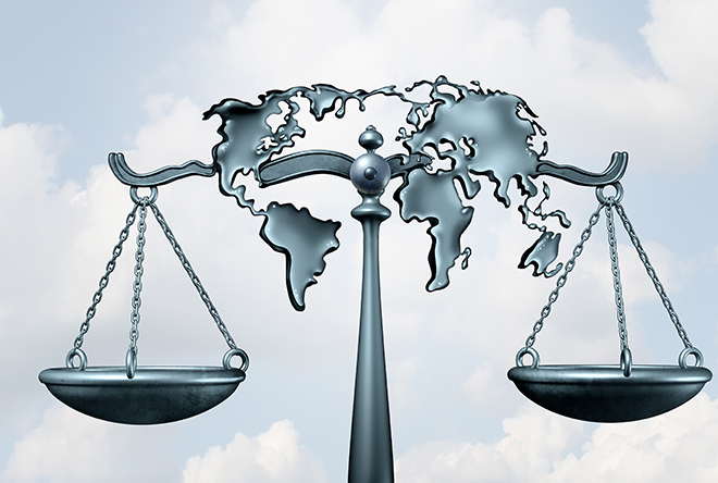 justice scale with world map behind it blue