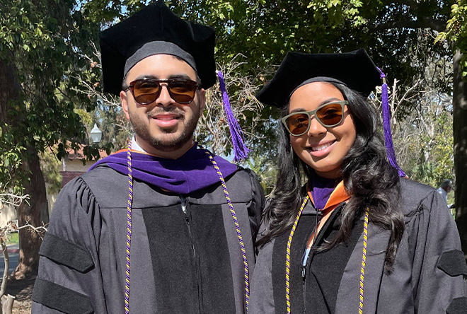 two students posting for a picture at commencement for California Western School of Law